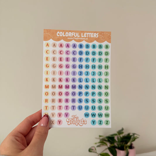 Printed sticker sheet with colorful alphabet letter stickers on glossy paper